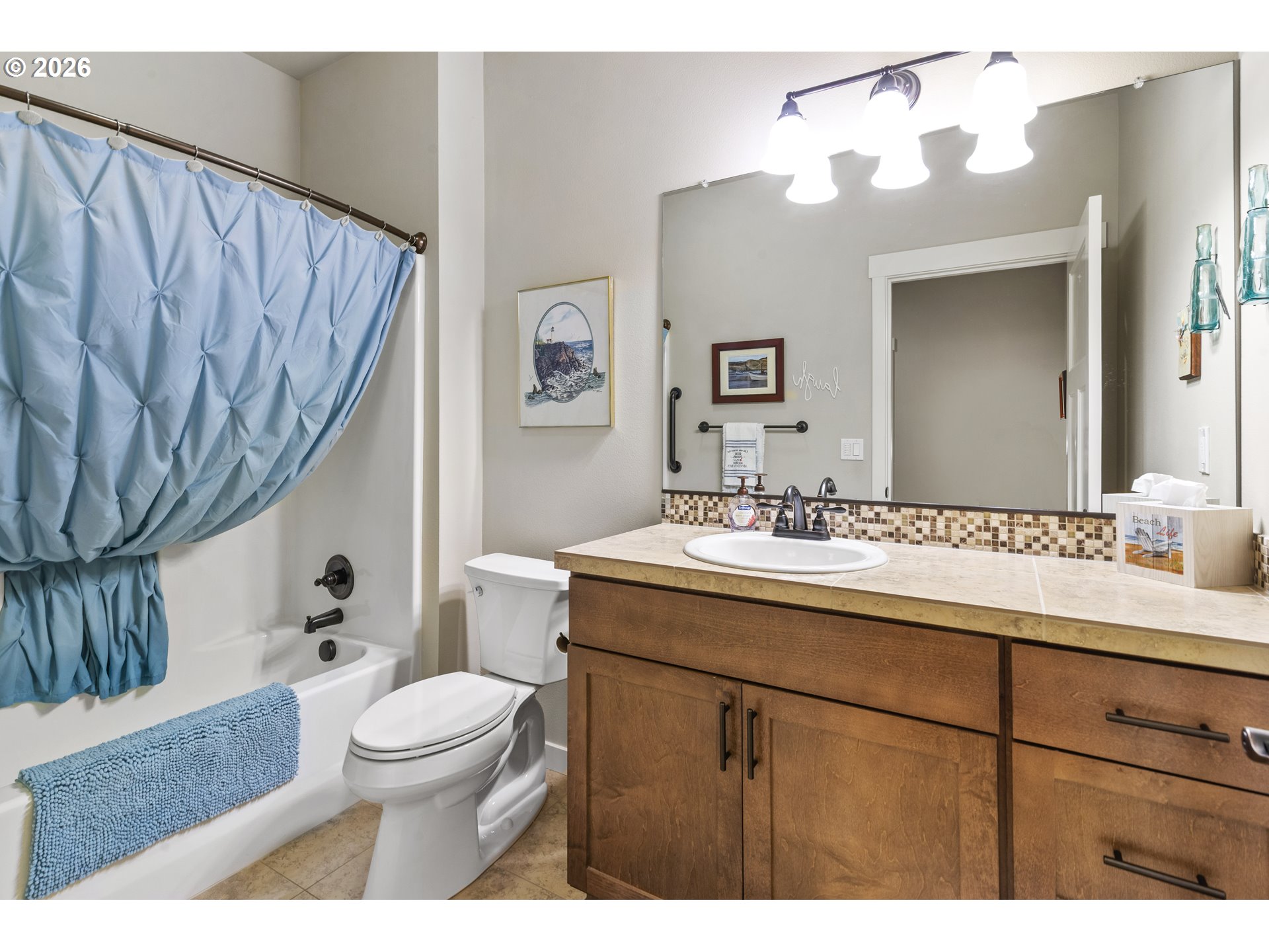 3110 Northeast 174th Street Ridgefield, WA 98642 - Photo 28 of 36 a bathroom with a sink a toilet and a mirror