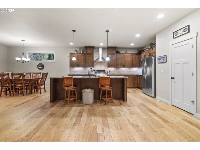 a kitchen with stainless steel appliances kitchen island a large island in the center