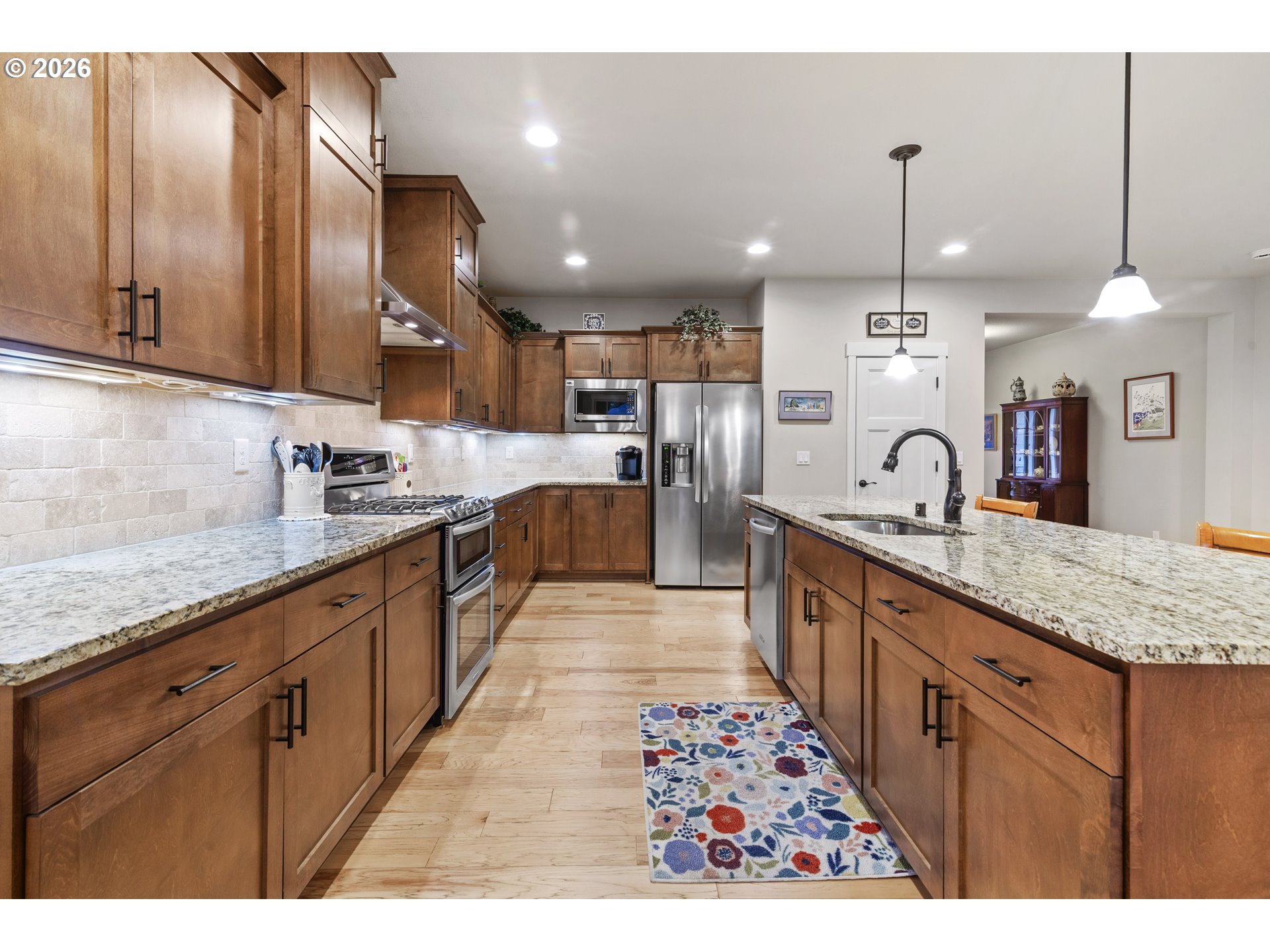 3110 Northeast 174th Street Ridgefield, WA 98642 - Photo 8 of 36 a large kitchen with kitchen island a large island in the center