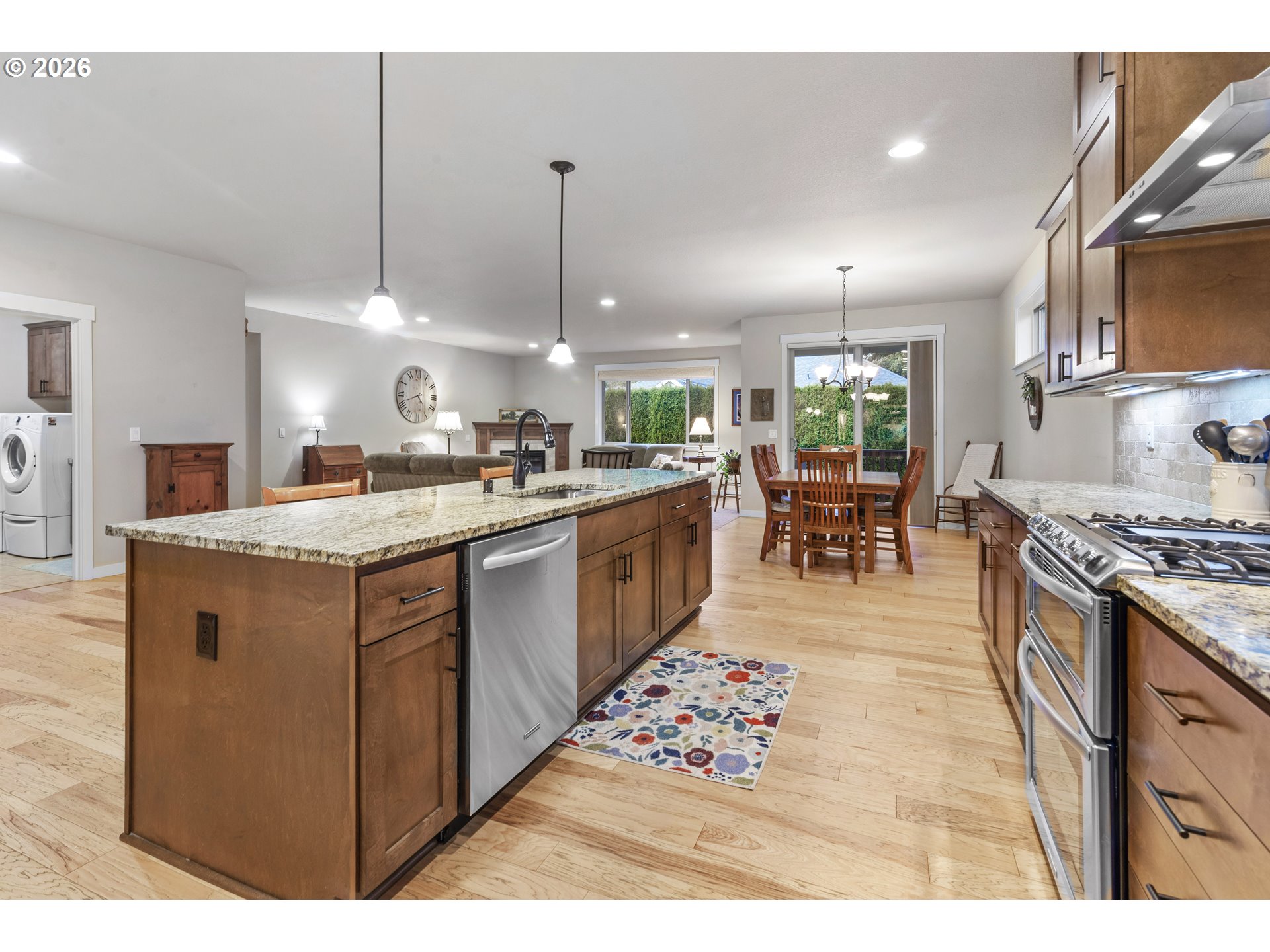 3110 Northeast 174th Street Ridgefield, WA 98642 - Photo 9 of 36 a kitchen with stainless steel appliances granite countertop a sink stove and refrigerator