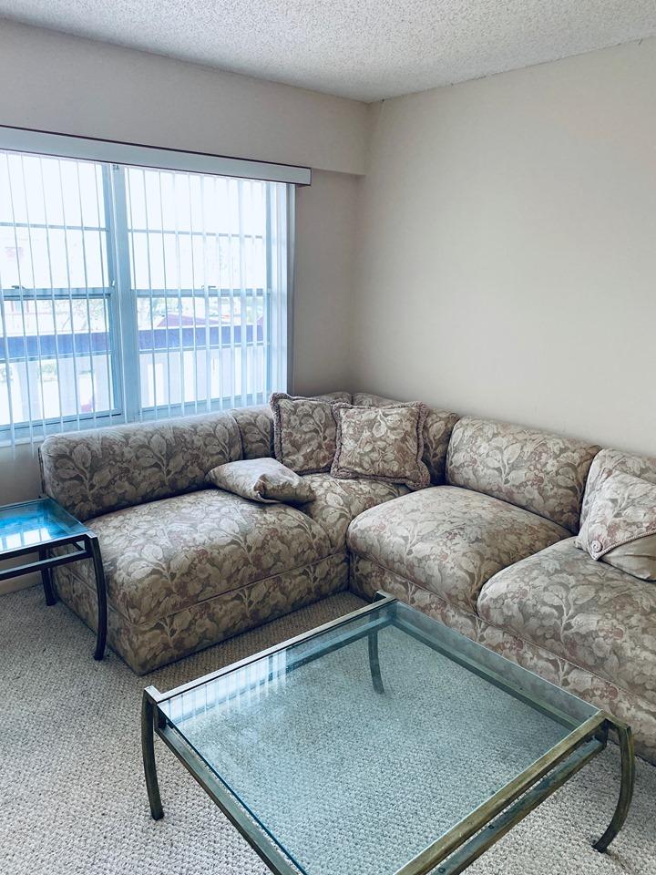 199 Fanshaw East, Unit 199 Boca Raton, FL 33434 - Photo 2 of 7 a living room with a couch