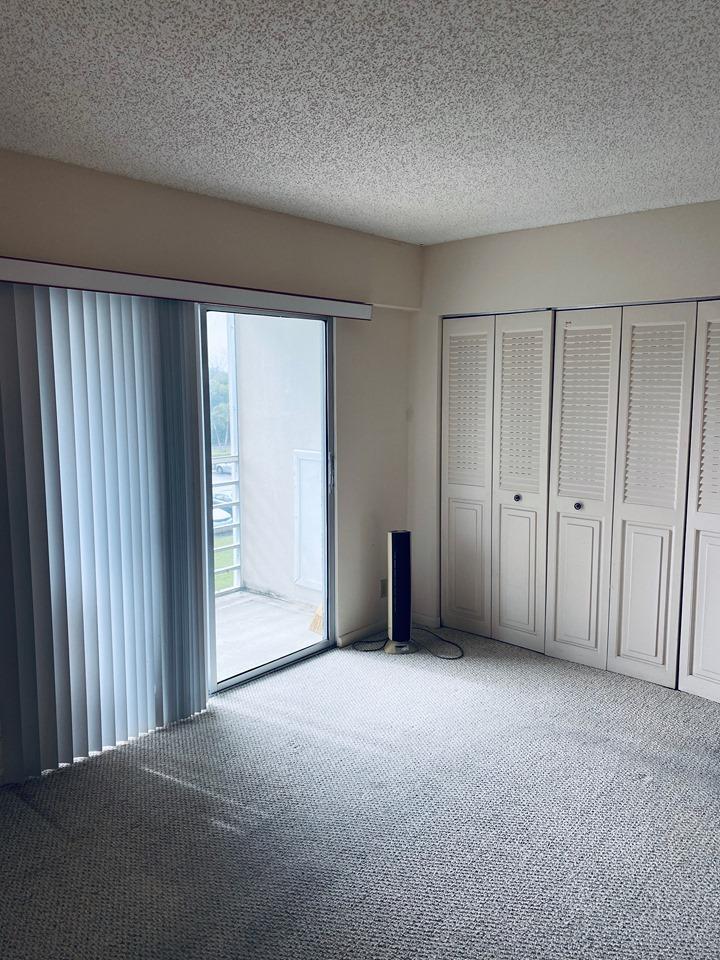 199 Fanshaw East, Unit 199 Boca Raton, FL 33434 - Photo 4 of 7 a view of an empty room with wooden door