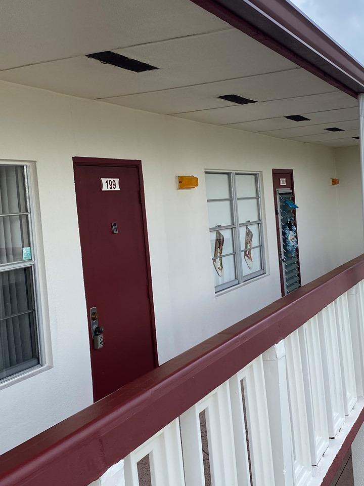 199 Fanshaw East, Unit 199 Boca Raton, FL 33434 - Photo 5 of 7 a view of a hallway with wooden floor and stairs