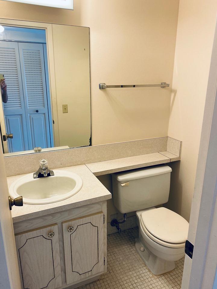 199 Fanshaw East, Unit 199 Boca Raton, FL 33434 - Photo 6 of 7 a bathroom with a sink a toilet and mirror