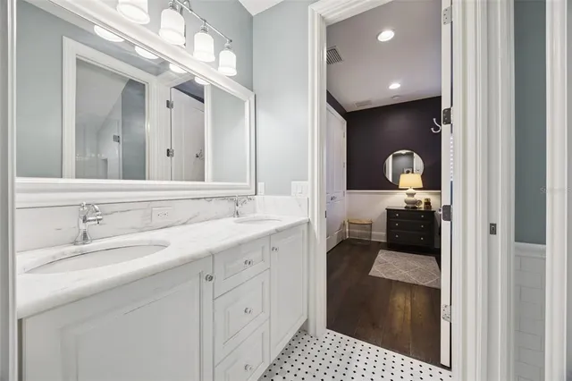 a bathroom with a sink mirror and toilet