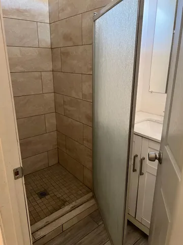 a bathroom with a glass door shower