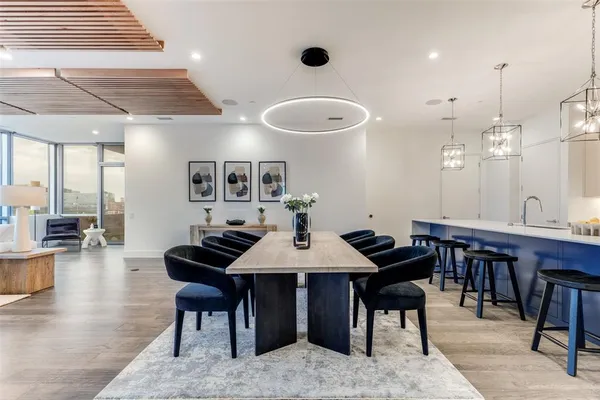 a view of a a dining room with furniture window and wooden floor