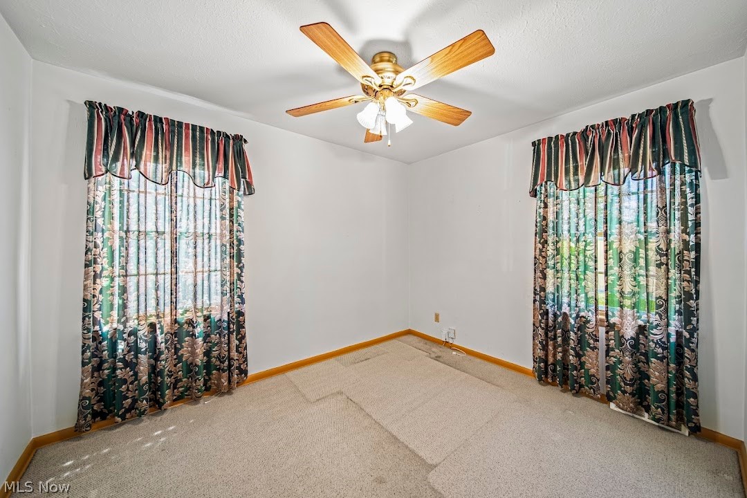 1738 Rockefeller Road Wickliffe, OH 44092 - Photo 23 of 35 Carpeted spare room with a healthy amount of sunlight, ceiling fan, and a textured ceiling