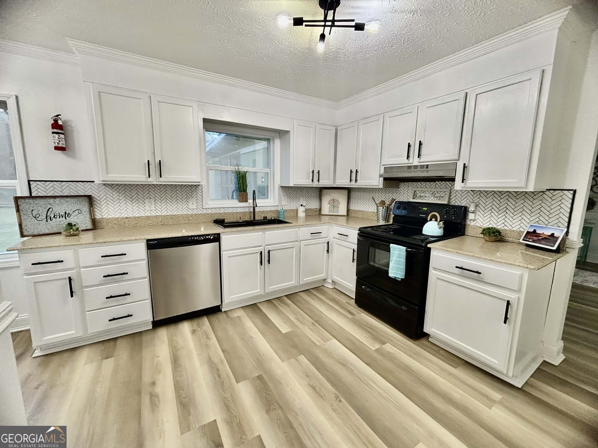 2800 South Estates Road Macon, GA 31216 - Photo 13 of 27 a kitchen with cabinets oven and a sink