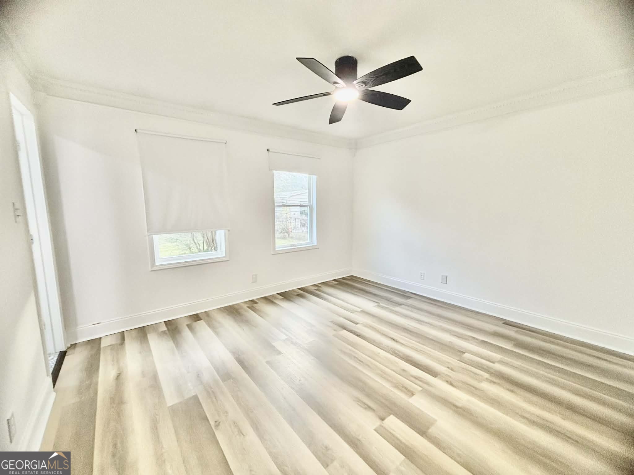 2800 South Estates Road Macon, GA 31216 - Photo 19 of 27 a view of empty room with wooden floor and fan