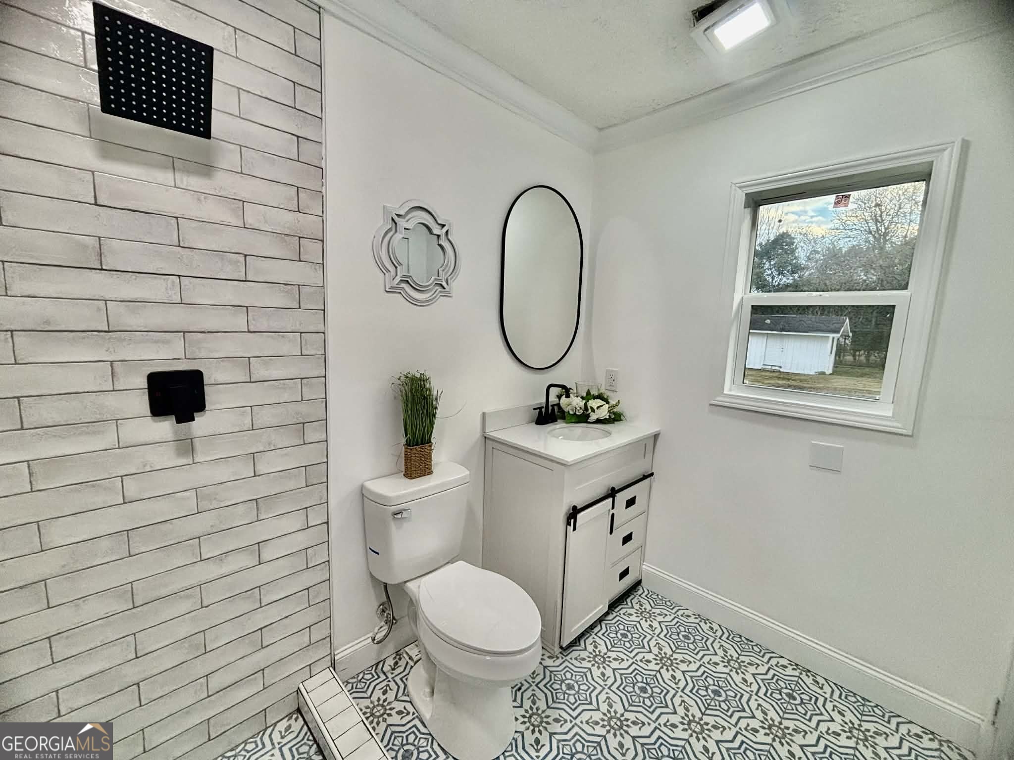 2800 South Estates Road Macon, GA 31216 - Photo 21 of 27 a bathroom with a toilet a sink and mirror