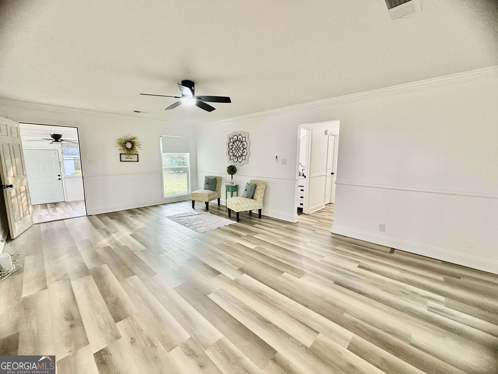 2800 South Estates Road Macon, GA 31216 - Photo 8 of 27 a view of a livingroom with wooden floor and a ceiling fan
