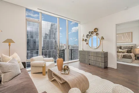 a bedroom with furniture and a large window