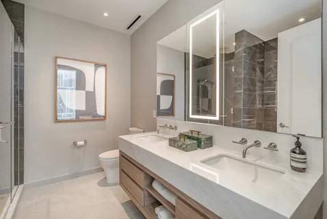 a bathroom with a granite countertop sink mirror and double