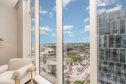 a view of a city from a living room filled with furniture