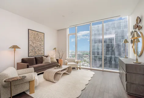 a living room with furniture and a floor to ceiling window