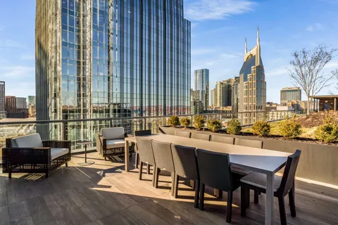 a swimming pool with outdoor seating and city view