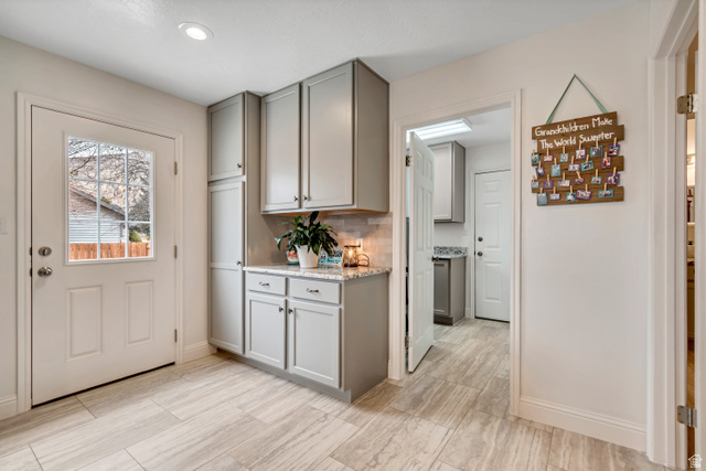 1697 North 500 West Mapleton, UT 84664 - Photo 12 of 50 Kitchen with gray cabinets, light stone counters, tasteful backsplash, and recessed lighting
