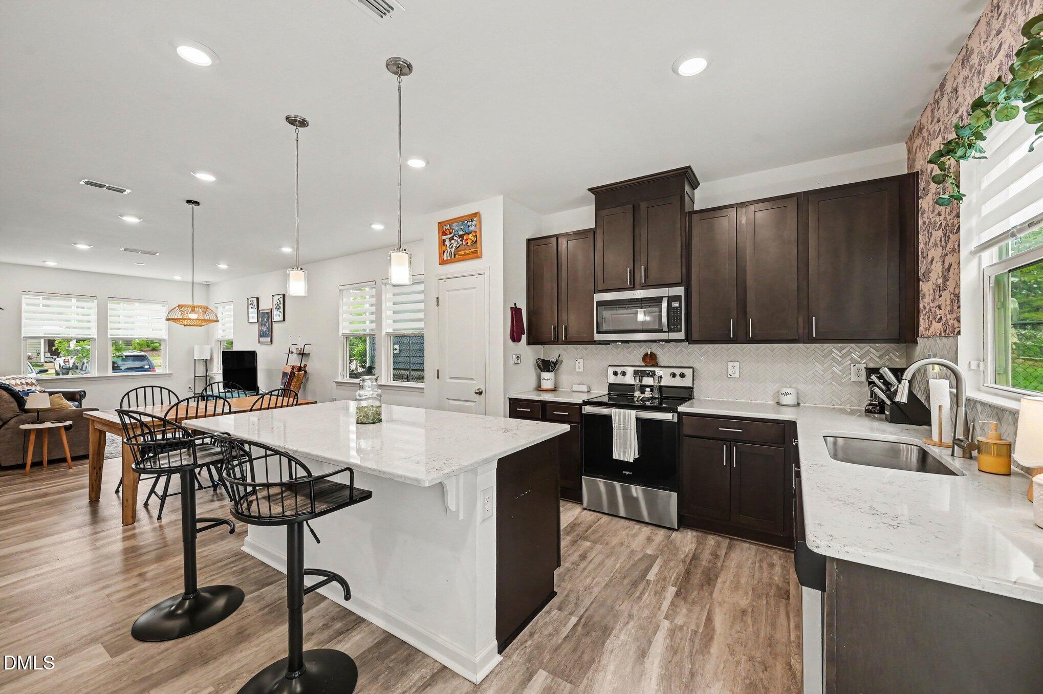 574 Hacksaw Trail Raleigh, NC 27610 - Photo 2 of 28 a kitchen with stainless steel appliances granite countertop sink stove top oven and cabinets