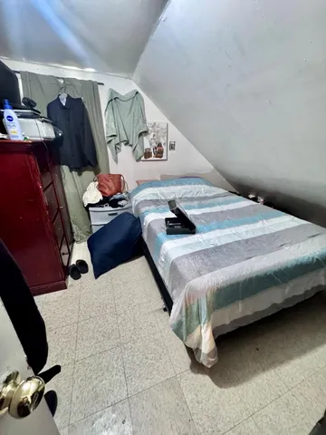 a bedroom with bed and window