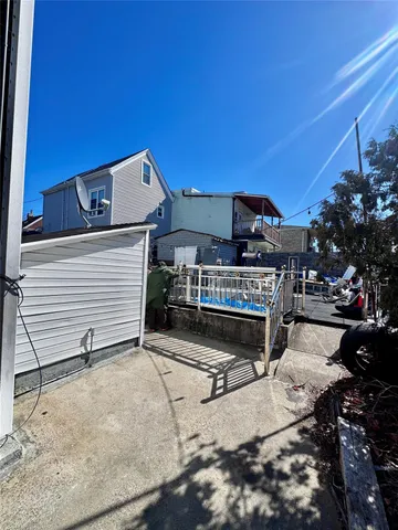 a view of a patio with a table and chairs under an umbrella