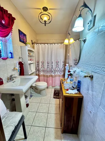 a dining room with furniture and a mirror