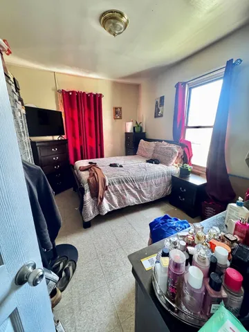 a bedroom with a bed and window