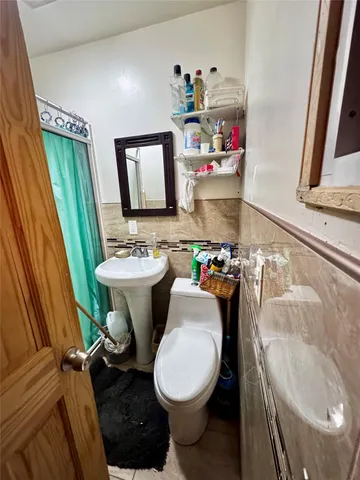 a bathroom with a sink toilet and mirror