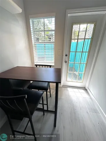 a table chair sitting in a room next to a window