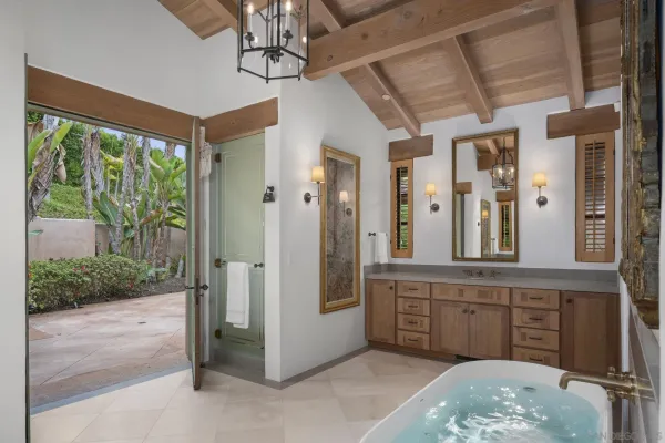 a spacious bathroom with a granite countertop sink and a mirror