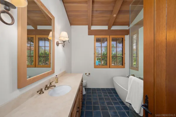 a spacious bedroom with a bed and a large window with the outer view