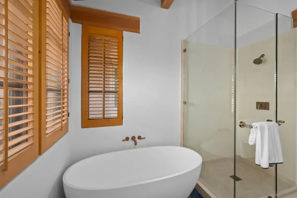 a front view of a house with a yard and potted plants