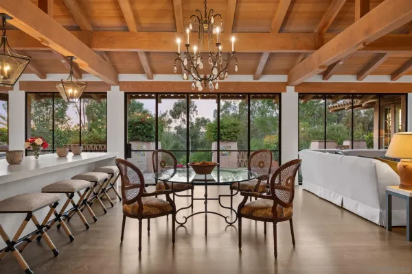 a view of a dining room with furniture large windows and wooden floor
