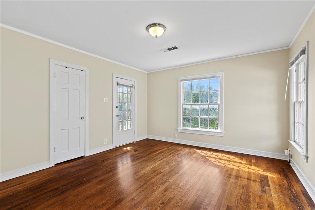 5927 Lewis Street Dallas, TX 75206 - Photo 13 of 19 a view of an empty room with wooden floor and a window