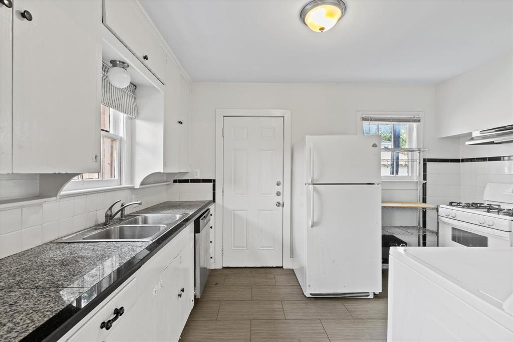 5927 Lewis Street Dallas, TX 75206 - Photo 8 of 19 a kitchen with stainless steel appliances granite countertop a refrigerator a stove and a sink