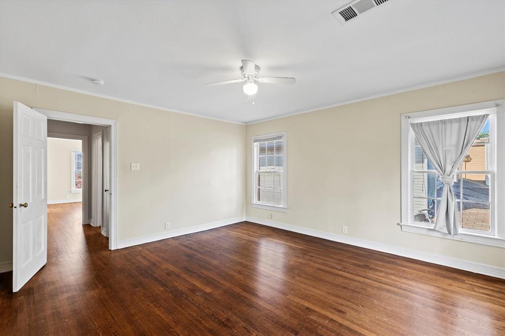 5927 Lewis Street Dallas, TX 75206 - Photo 10 of 19 an empty room with wooden floor chandelier fan and windows