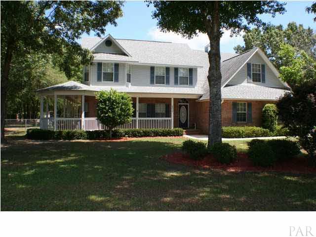 6012 Saddle Club Road Pace, FL 32571 - Photo 1 of 24 Beautiful, custom home with wrap around porch nestled on 2 acres.