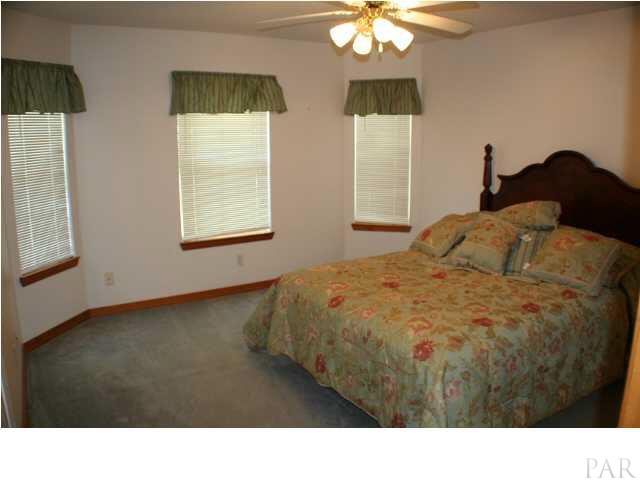 6012 Saddle Club Road Pace, FL 32571 - Photo 15 of 24 One of the two bedroom upstairs ~ Overlooks the front yard and has perfect bay window design. This bedroom measures 14x12 and the third bedroom measures 13x11.