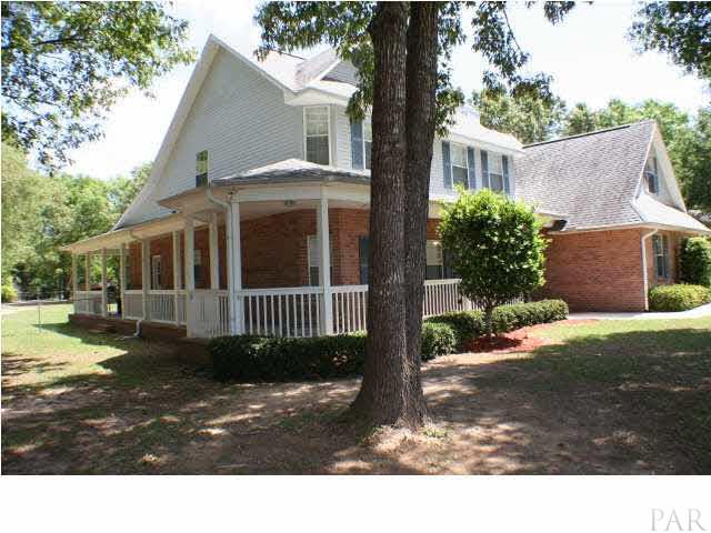 6012 Saddle Club Road Pace, FL 32571 - Photo 2 of 24 Did I mention the wrap around porch? It goes from the front door all the way around the left to the back of the home.