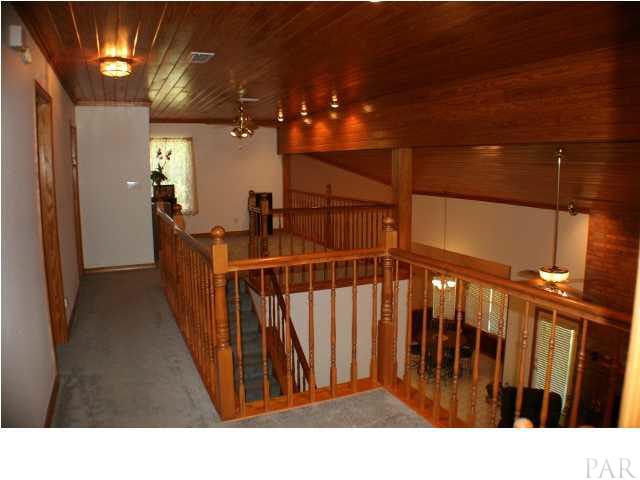 6012 Saddle Club Road Pace, FL 32571 - Photo 3 of 24 Landing area would be great office or play area ~ It has two parts. TONGUE AND GROOVE PINE ceilings give the feeling of a cozy mountain lodge.
