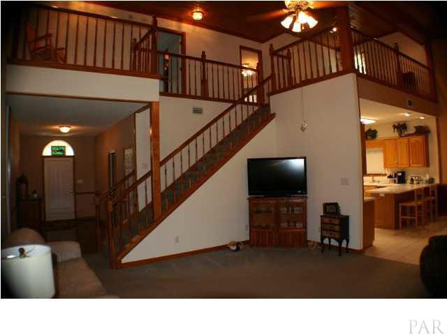 6012 Saddle Club Road Pace, FL 32571 - Photo 7 of 24 So much wood work in this home and the lighting is situated to highlight the beauty of this wood work.