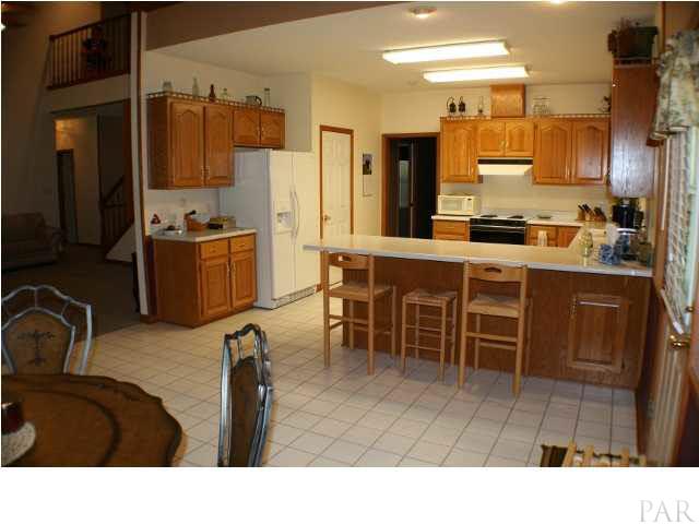 6012 Saddle Club Road Pace, FL 32571 - Photo 10 of 24 Breakfast bar for quick meals on the go or entertaining with your cooking skills.