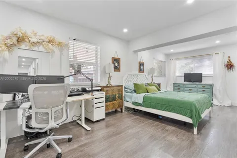 a living room with furniture window and wooden floor