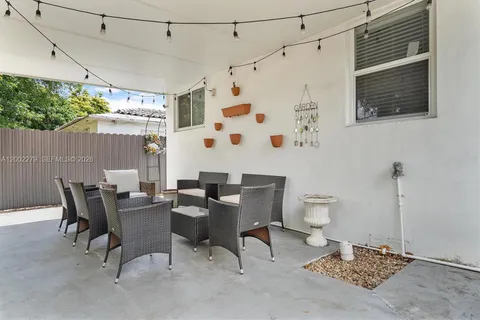 a view of a patio with table and chairs