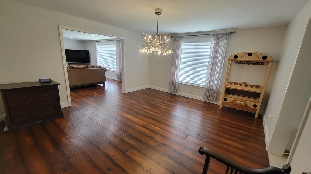 9 David Drive Pelham, NH 03076 - Photo 18 of 42 a living room with furniture and a chandelier