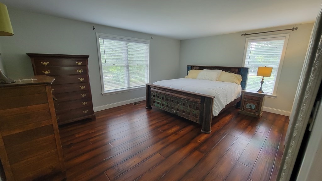 9 David Drive Pelham, NH 03076 - Photo 23 of 42 a spacious bedroom with a bed and wooden floor