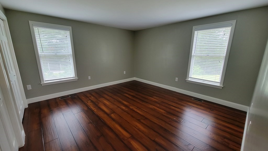 9 David Drive Pelham, NH 03076 - Photo 25 of 42 an empty room with wooden floor and windows