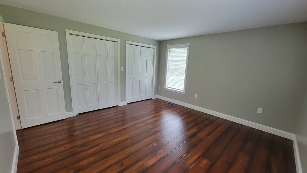 9 David Drive Pelham, NH 03076 - Photo 26 of 42 a view of an empty room with wooden floor and a window