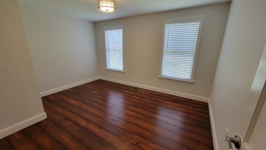 9 David Drive Pelham, NH 03076 - Photo 27 of 42 an empty room with wooden floor and windows