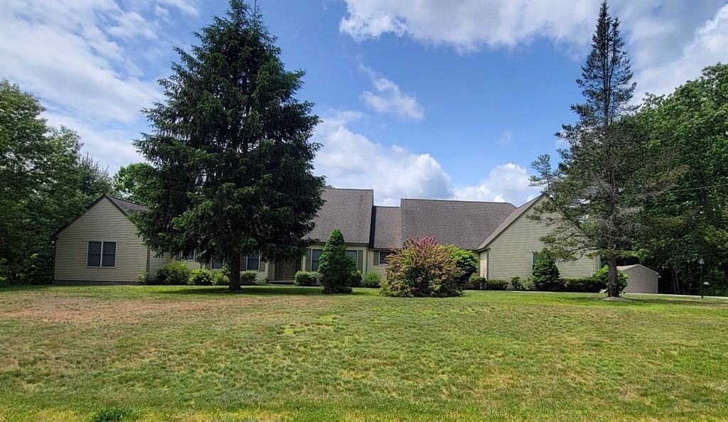 9 David Drive Pelham, NH 03076 - Photo 3 of 42 a front view of house with yard and trees